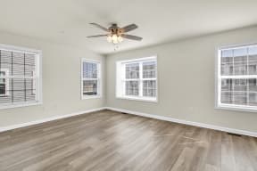 living room with hardwood floors and ceiling fan natural light