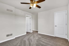 bedroom with grey carpet and ceiling fan natural light