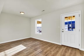 basement with hardwood floors and door leading to walk-out basement