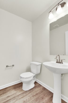 half bath with hardwood floors  at Franklin Square Apartments/Townhomes, Pennsylvaniaand ceramic toilet and sink brushed nickel finishes and lighting  at Franklin Square Apartments/Townhomes, Pennsylv