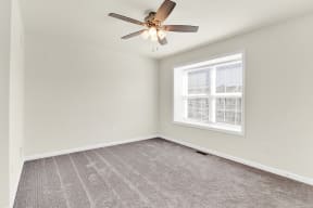 bedroom with grey carpet and ceiling fan natural light  at Franklin Square Apartments/Townhomes, Pennsylvania