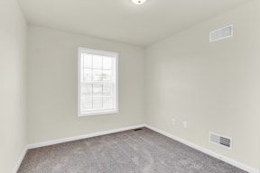 bedroom with grey carpet natural light  at Franklin Square Apartments/Townhomes, New Freedom, PA