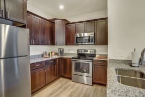 kitchen with stainless steel appliances expresso cabinets