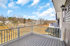 composite deck with white railing off kitchen sliding glass doors country view  at Franklin Square Apartments/Townhomes, Pennsylvania