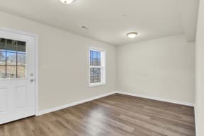 basement with hardwood floors and door leading to walk-out basement