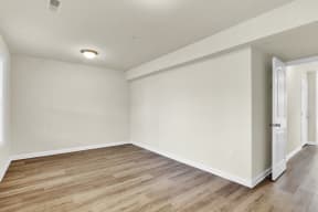 basement with hardwood floors and hallway to upstairs