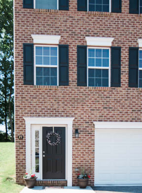 brick and beige siding beige garage doors