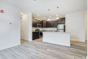 Open floor kitchen and living room island sink  at Franklin Square Apartments/Townhomes, New Freedom, PA