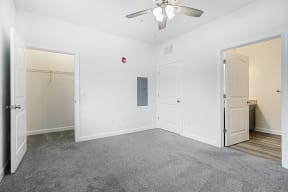 Bedroom with grey carpet and walk in closet