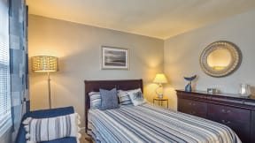 a bedroom with a bed and a chair