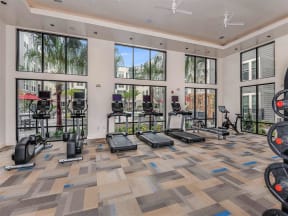 Coda Orlando treadmills facing luxurious swimming pool in Orlando, FL apartments' fitness center