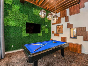 Coda Orlando pool table room with huge TV as clubhouse entertainment for Orlando, FL apartment rental residents