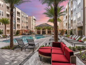 View of resort-style swimming pool, enormous clubhouse and efficient BBQ grill section in Coda Orlando apartments for rent