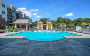 Well-maintained swimming pool and lounging chairs in Pointe at Prosperity Village apartment rentals