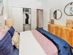 Bedroom with a double sliding door closet and doorway exit to the main apartment living space