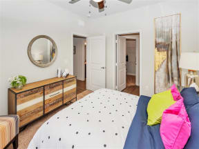 Carpeted bedroom with a doorway leading to a closet and a doorway leading to the main living space