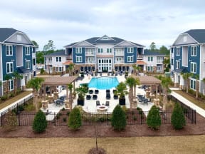 Aerial view of the 3 apartment buildings and the pool at Haven Pointe at Carolina Forest