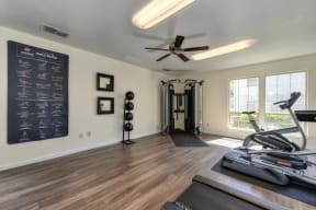 Fitness Center Gym with Workout Cardio machines, Weight Training Machines, Hardwood Inspired Floors and Treadmill. 