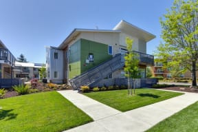 Apartment Exterior with Walking Path, Grass, Stairs and Trees