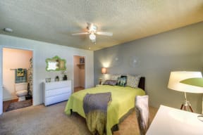 Living Room with View of Bathroom, Mattress with Green Comforter, at Pinecrest Apartments, Davis, California