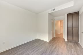 Bedroom with Hardwood Inspired Floor, White Walls 