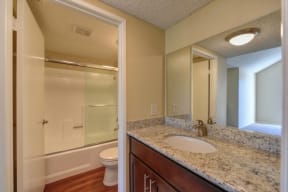 Bathroom with Shower, Vanity, Toilet and White/Brown Hand Towel