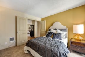 Bedroom with Wood Inspired Floors, Carpet and mattress full of decorative pillows