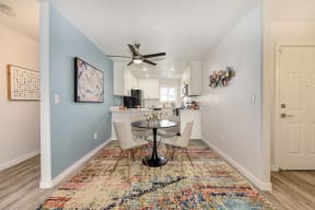 Dining Area with Hallway, Table, Rugs and Ceiling Fan/Light