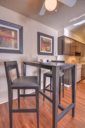Dining Area Kitchen with Hardwood Floors, Refrigerator, Dishwasher, and High Chairs