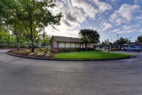 Entrance Road with Road, Grass, Trees and Building Exterior