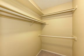 Extended Closet with White Walls and Hanger Rod