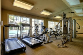 Fitness Center with Treadmills, Ellipticals, Weight Machines and Fluorescent Lights