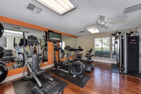 Fitness Center with Ellipticals, Hardwood Inspired Floor, Excercise Bike, Mirror and Flat Screen Television