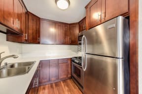 Kitchen with Wood Cabinets, Refrigerator, and Sink
