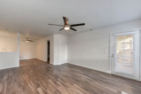  Living Room with Ceiling Fan,  Wood Inspired Floor and White Walls