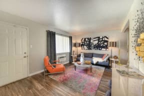 Living Room with Hardwood Inspired Floors, Orange Chairs and Window