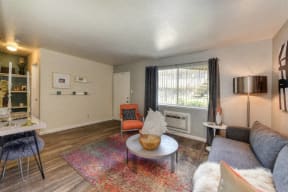 Living Room with Hardwood Inspired Floors, Orange Chairs and Window