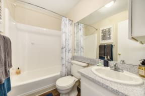 Bathroom with Hardwood Inspired Floor, Toilet, Bathtub and Sink