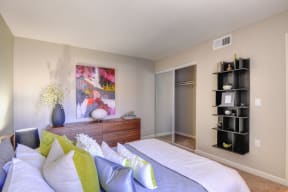 Large Bedroom with Closet Storage Space, Carpet, Black Shelves, Wood Dresser, Abstract Mural