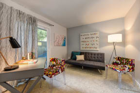 Guest Bedroom with Gray Sofa, Colorful Chairs, Gray Desk and View of Sliding Patio Door