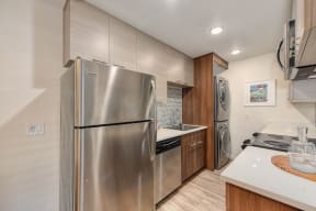 Kitchen with Stainless Steel Refrigerator, Hardwood Inspired Floors, Dishwasher and Countertop