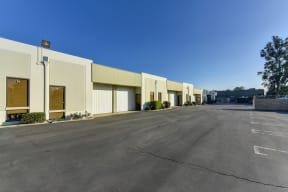 Oak Business Center parking lot showing building with office spaces and larger warehouse roll-up doors. 