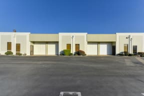 Oak Business Center parking lot showing building with larger warehouse doors. 
