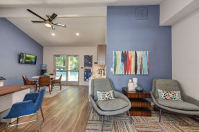 Office Entry with Hardwood Inspired Floor, Ceiling Fan/Light, Desks, Blue Chairs and View of Pool