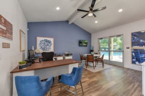 Office Entry with Hardwood Inspired Floor, Ceiling Fan/Light, Desks, Blue Chairs and View of Pool