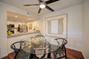 Model home dining area with ceiling fan. Dining table is set for four.