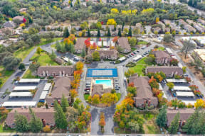 Drone shot of the entire Rocklin Manor community. Showing all buildings, Leasing office, pool, sports court and the mature landscaping.