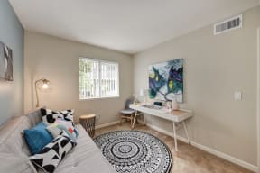 Spare Bedroom with Desk, painting and window with Black/White designed Rug
