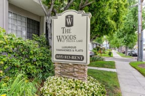 The Woods monument signage located outside of the community entrance. 