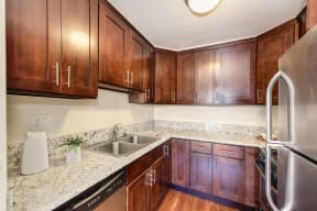 Kitchen with Wood Cabinets, Refrigerator and Sink